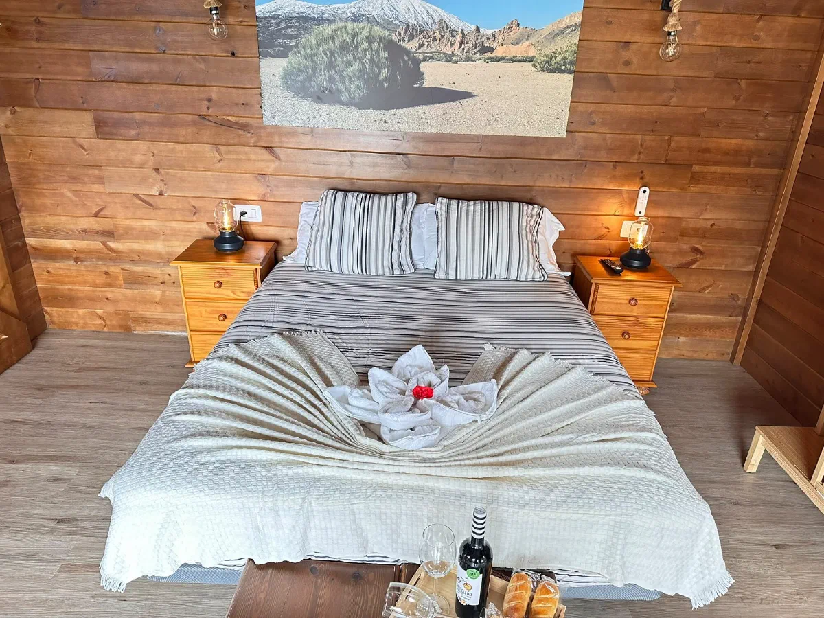 Fabulosa: double bed under a volcanic landscape painting in a wooden room